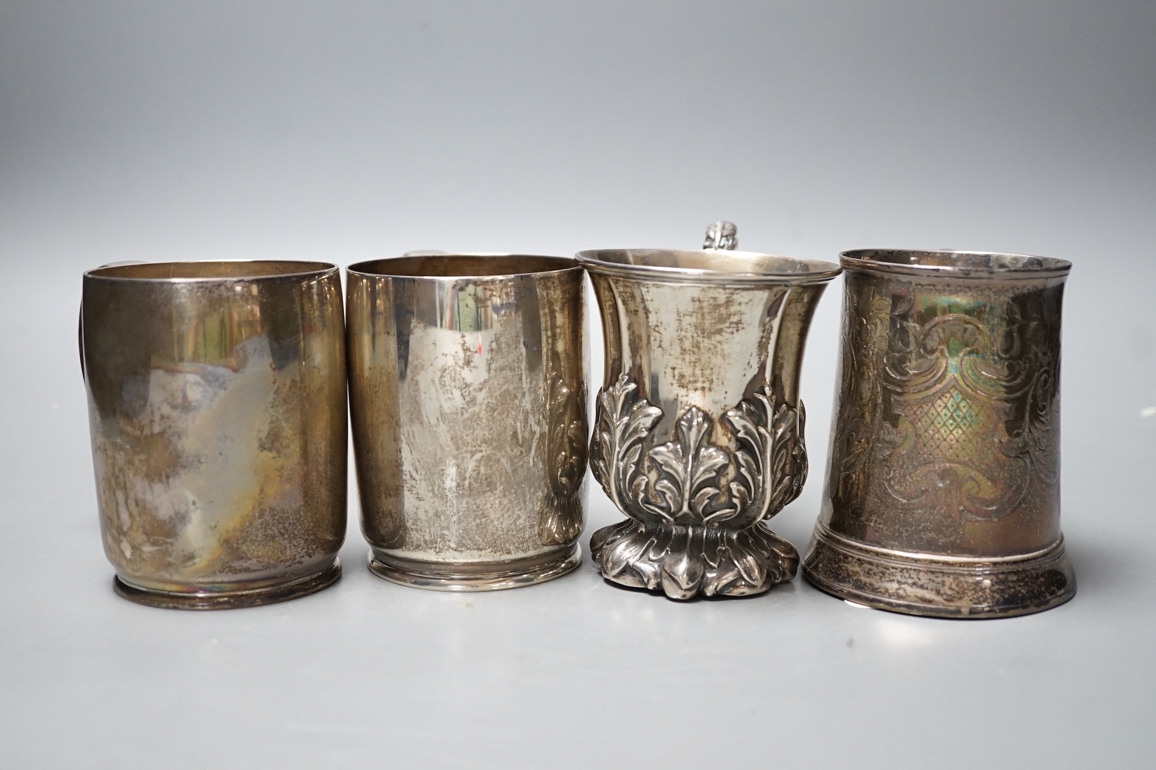 Four assorted silver mugs, including engraved George III, London, 1769, 94mm and a pair by Wakely & Wheeler, London, 1948/9, 26.1oz.